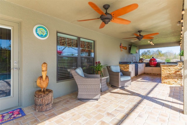 view of patio / terrace with a sink, ceiling fan, and exterior kitchen