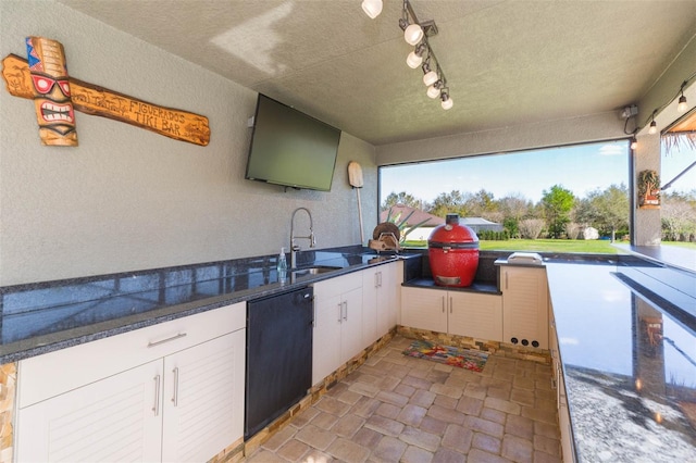 view of patio featuring an outdoor kitchen and a sink
