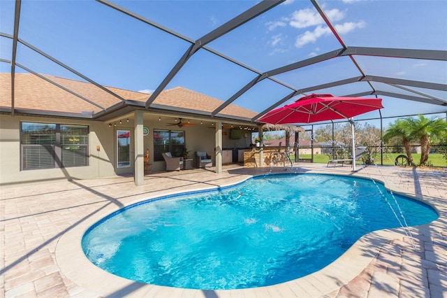 outdoor pool with a lanai, a patio, outdoor dry bar, and ceiling fan