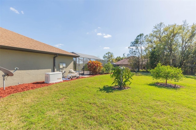 view of yard with a lanai