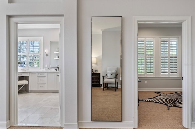 corridor with light carpet and baseboards