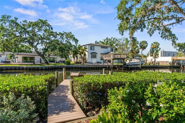 view of home's community with a dock and a water view