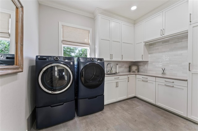washroom featuring separate washer and dryer, recessed lighting, crown molding, cabinet space, and a sink