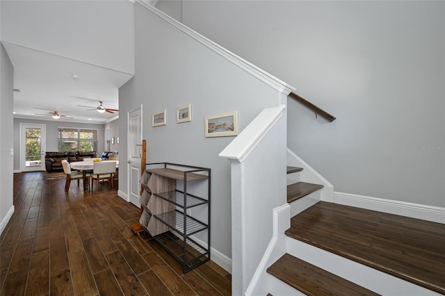 stairway featuring baseboards and wood finished floors