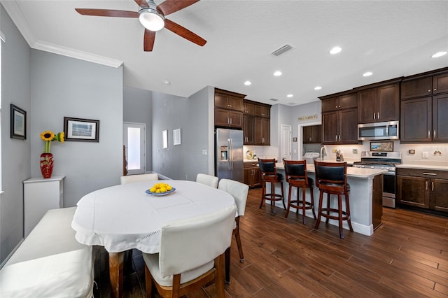 dining room featuring recessed lighting, visible vents, dark wood finished floors, and crown molding