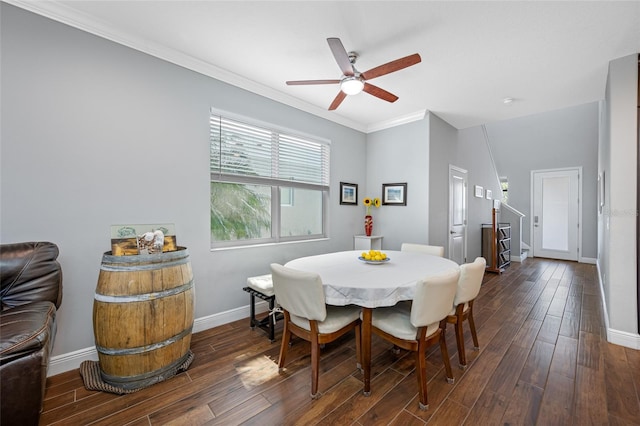 dining space featuring baseboards, a ceiling fan, dark wood-style floors, and crown molding