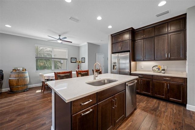 kitchen featuring a sink, stainless steel appliances, dark wood-type flooring, and visible vents