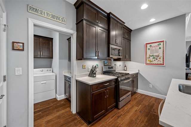 kitchen featuring washer / dryer, dark wood-style floors, dark brown cabinetry, and stainless steel appliances