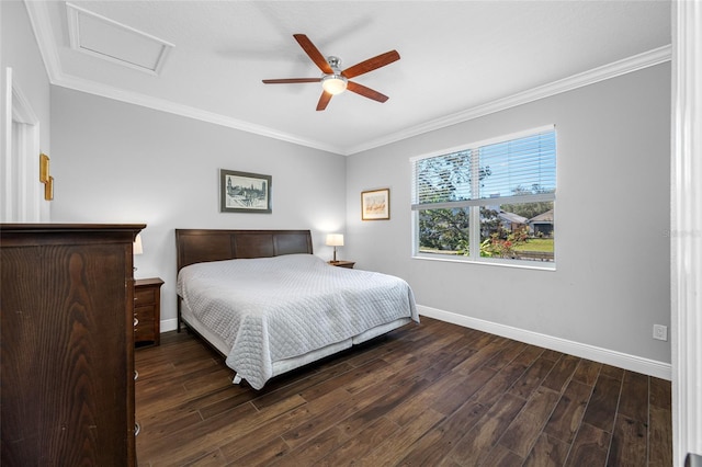 bedroom with baseboards, attic access, wood finished floors, and ornamental molding