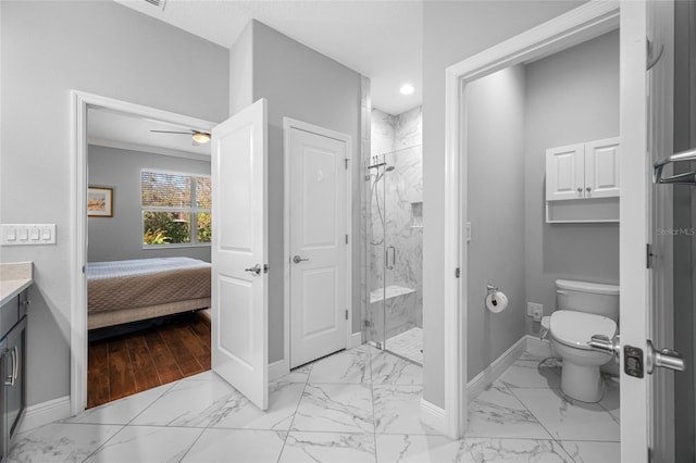 bathroom featuring a shower stall, baseboards, toilet, marble finish floor, and vanity