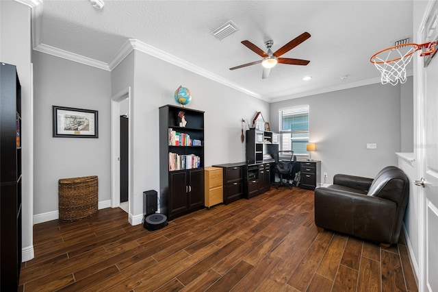 office area featuring dark wood finished floors, visible vents, a ceiling fan, and ornamental molding