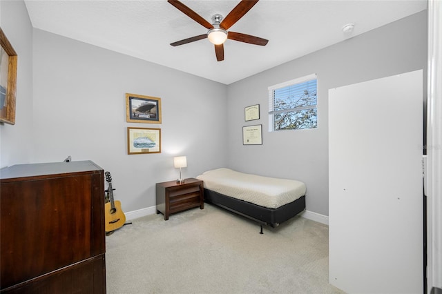 bedroom featuring carpet flooring, a ceiling fan, and baseboards