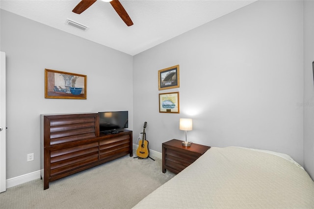 carpeted bedroom featuring a ceiling fan, baseboards, and visible vents