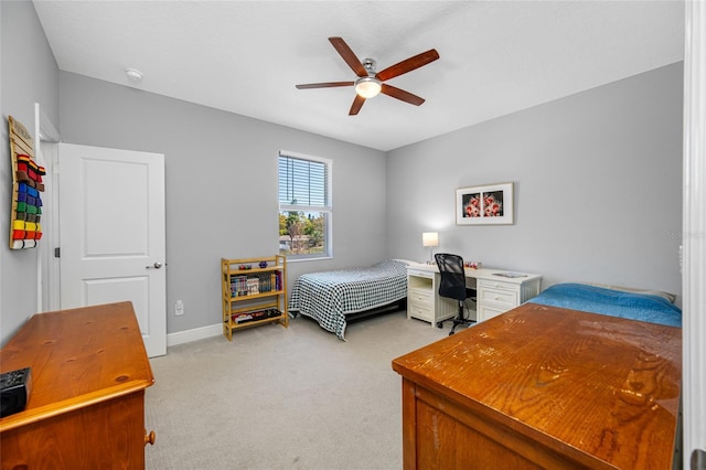 bedroom with ceiling fan, baseboards, and light carpet