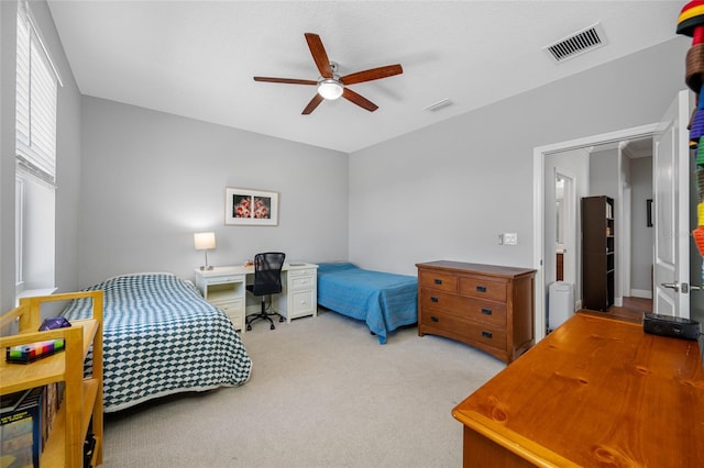 carpeted bedroom with visible vents and ceiling fan