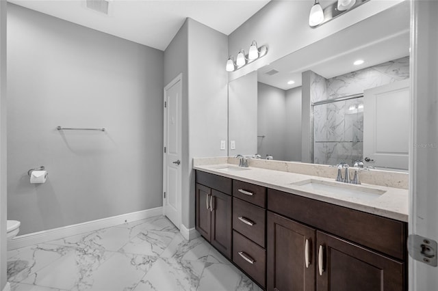 full bathroom featuring a marble finish shower, visible vents, baseboards, and a sink