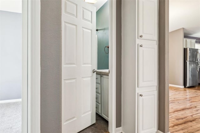 bathroom with baseboards and wood finished floors