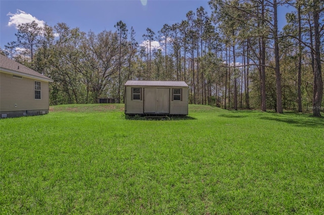 view of yard featuring a storage unit and an outbuilding