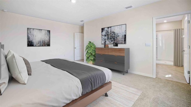 bedroom with recessed lighting, carpet floors, visible vents, baseboards, and ensuite bath