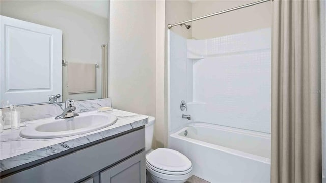 bathroom featuring vanity, shower / tub combination, and toilet