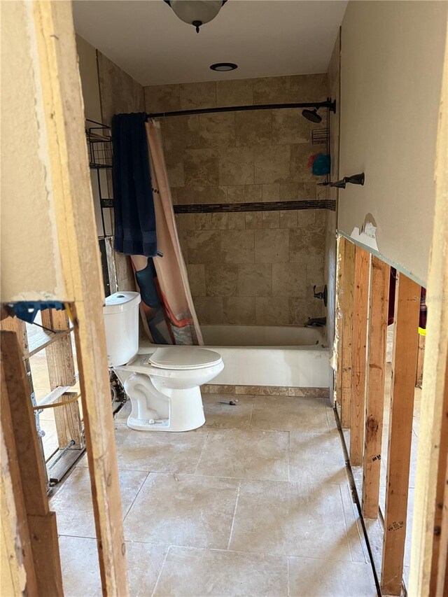 bathroom with shower / bath combo and toilet