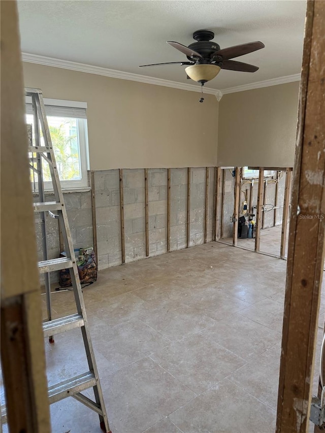 unfurnished room with ceiling fan and ornamental molding