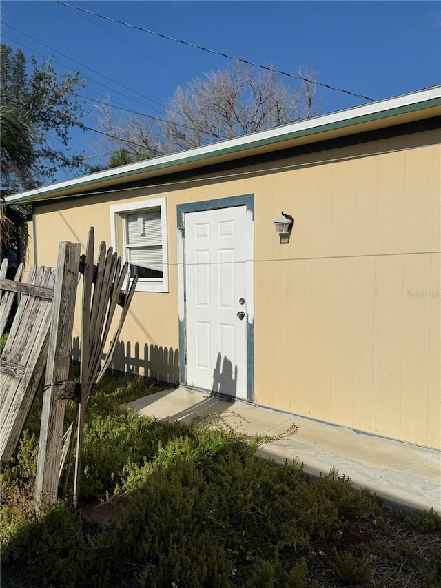 doorway to property featuring fence