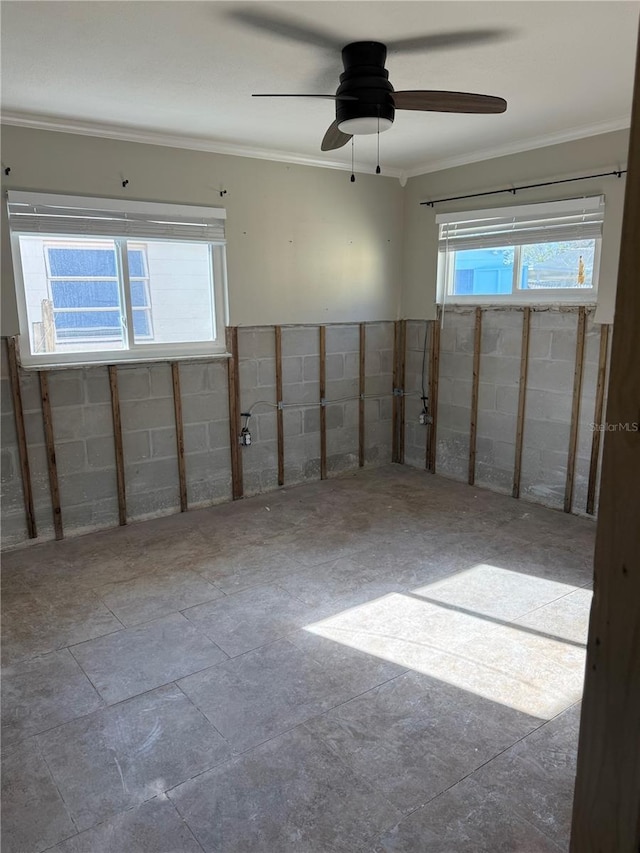 unfurnished room with a ceiling fan and crown molding