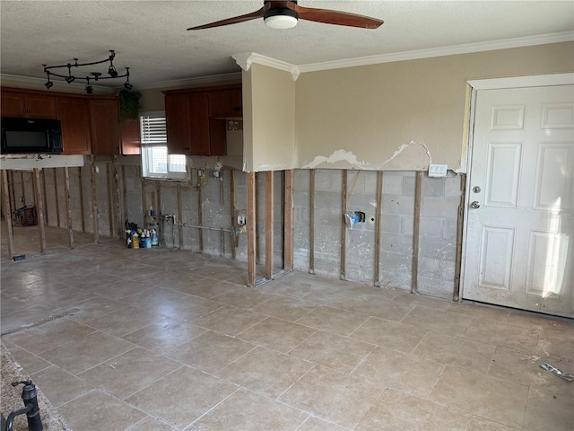 spare room featuring ceiling fan, a textured ceiling, and crown molding