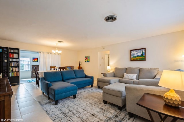 living room featuring tile patterned flooring, visible vents, and an inviting chandelier