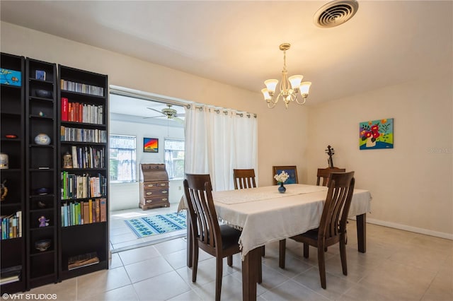 tiled dining space featuring visible vents, a notable chandelier, and baseboards