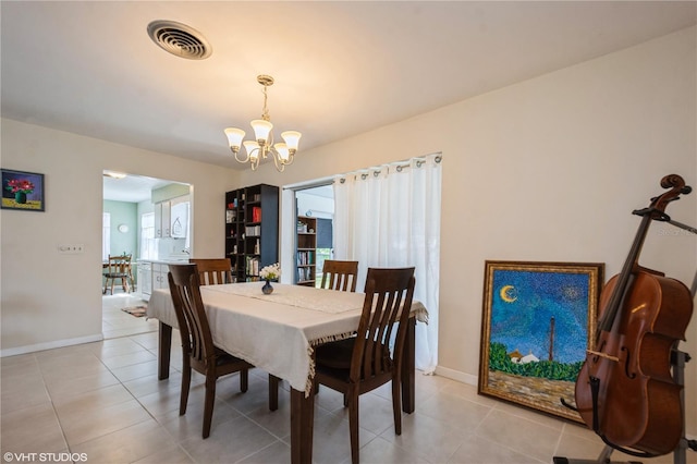 dining room with an inviting chandelier, baseboards, light tile patterned floors, and visible vents