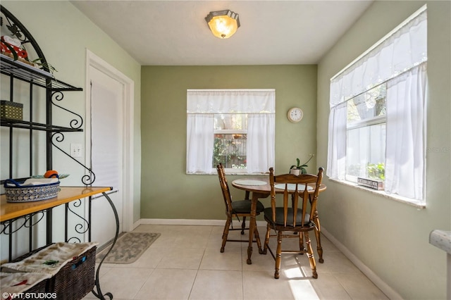 dining room with light tile patterned floors and baseboards