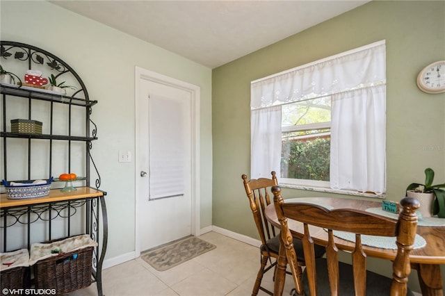 dining room featuring baseboards and light tile patterned flooring