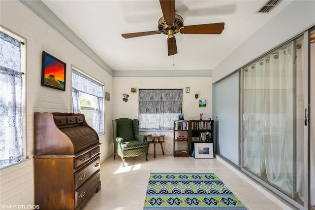 sitting room with ceiling fan, light tile patterned flooring, and visible vents