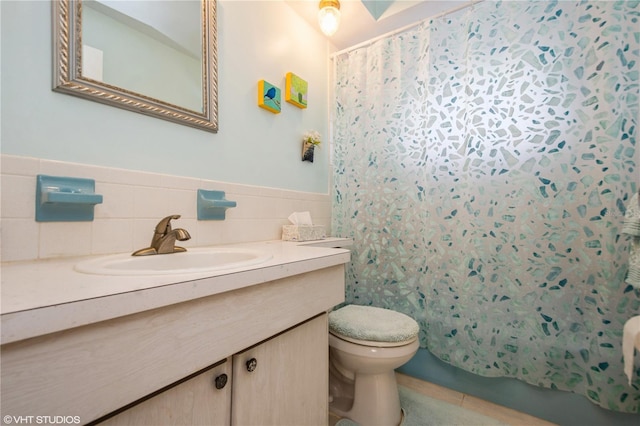 full bath featuring toilet, a wainscoted wall, vanity, tile walls, and shower / bath combination with curtain