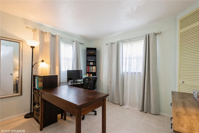 office space featuring light tile patterned floors and baseboards