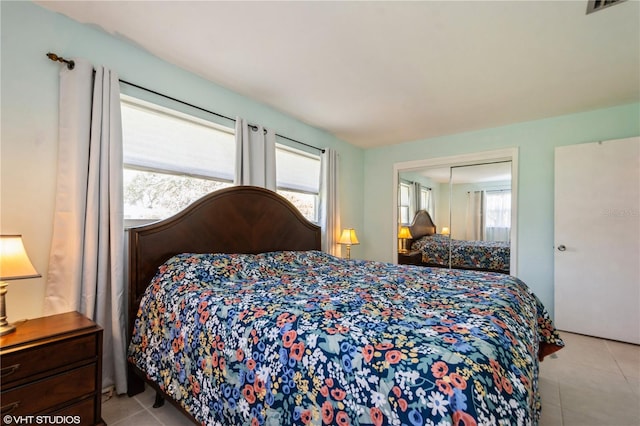 tiled bedroom with a closet