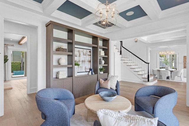 living area featuring an inviting chandelier, stairs, and beamed ceiling