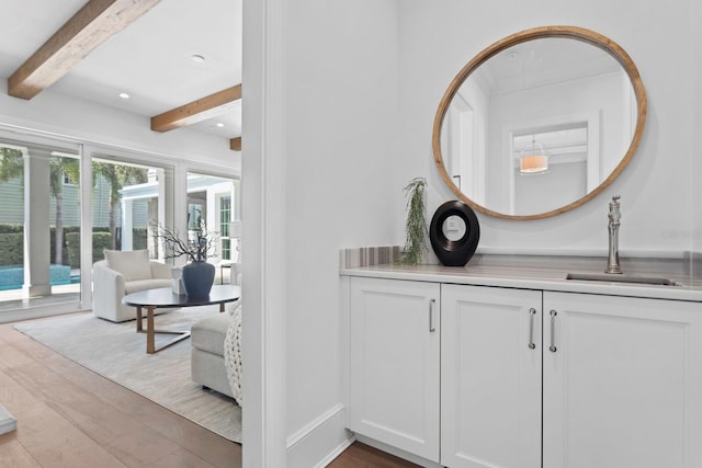 bathroom with vanity, wood finished floors, beam ceiling, and recessed lighting