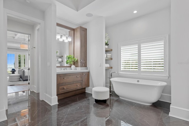 full bathroom with recessed lighting, marble finish floor, a soaking tub, and vanity