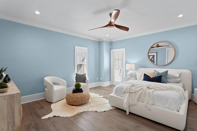 bedroom with crown molding, wood finished floors, and baseboards