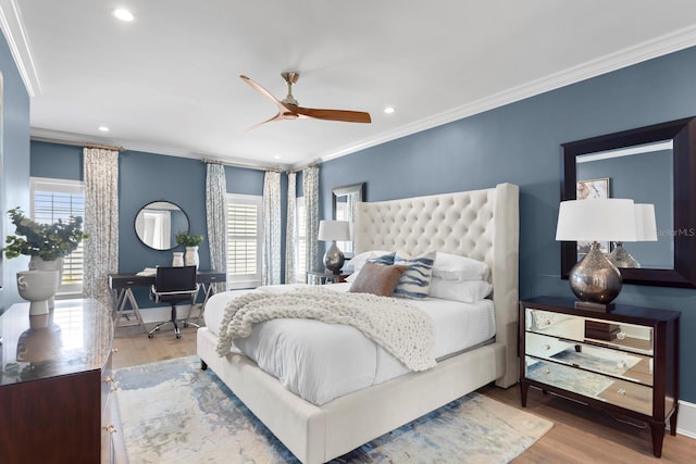 bedroom with ornamental molding, recessed lighting, multiple windows, and wood finished floors