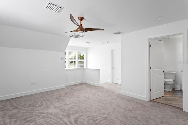 interior space with light colored carpet, visible vents, ceiling fan, and baseboards