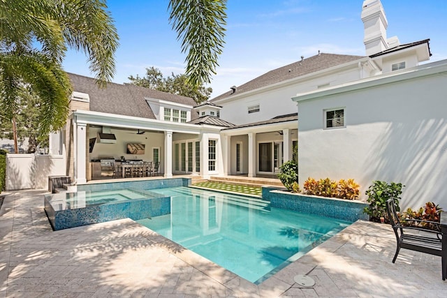 rear view of property with a pool with connected hot tub, a patio area, ceiling fan, and fence