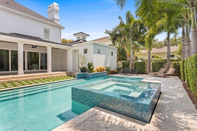 view of swimming pool featuring ceiling fan, an in ground hot tub, and a patio area