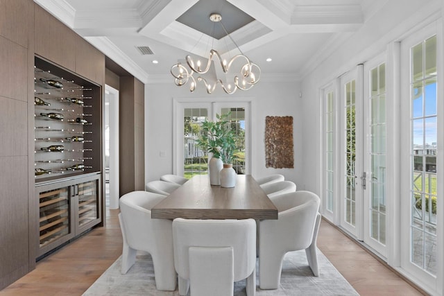 dining area with light wood-style floors, plenty of natural light, visible vents, and a notable chandelier