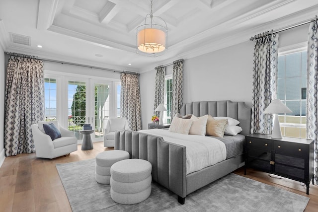 bedroom with visible vents, coffered ceiling, wood finished floors, crown molding, and french doors