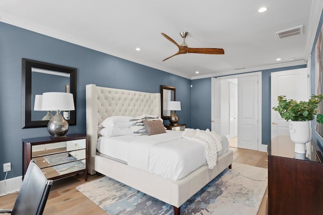 bedroom with recessed lighting, visible vents, light wood-style flooring, ornamental molding, and baseboards