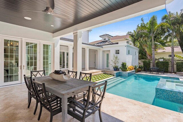 view of pool featuring a patio, outdoor dining area, a ceiling fan, french doors, and a fenced in pool